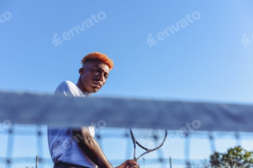 Preview: Young man seen playing tennis shot from low angle