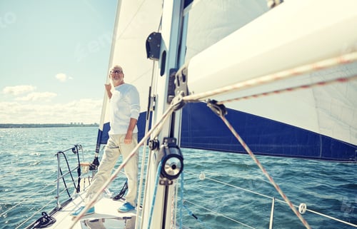 Preview: senior man on sail boat or yacht sailing in sea