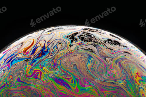 Preview: Closeup of a bubble covered with colorful paint swirls on black background