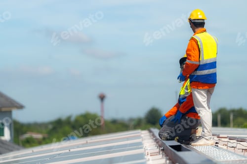 Preview: Worker Technicians are working to construct solar panels system on roof.