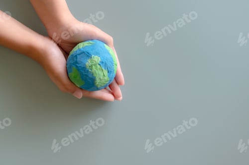 Preview: Hands holding earth paper and water paint. Concept of sustainability environment protection