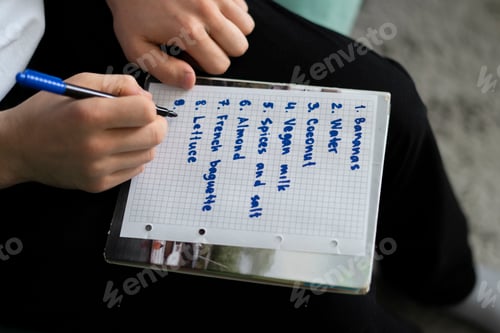 Preview: writing shopping list on the paper, buying reminder