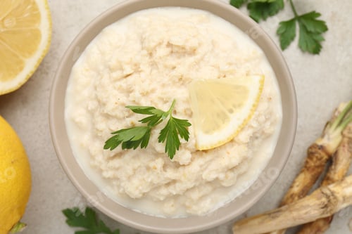 Preview: Tasty horseradish sauce with parsley, lemon slice and roots on light table, flat lay