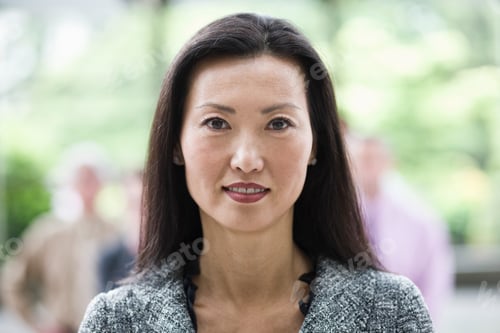 Preview: Portrait of an Asian businesswoman in the lobby of a convention center.