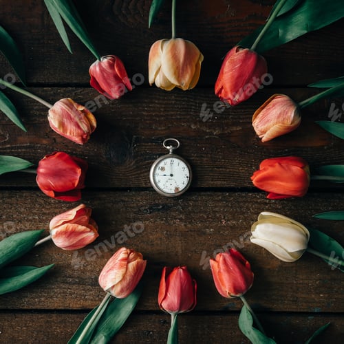 Preview: Vintage watch with creative arrangement of tulips on wooden background