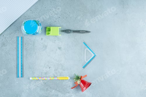 Preview: Arrangement of stationery products and a decorative bell on marble background