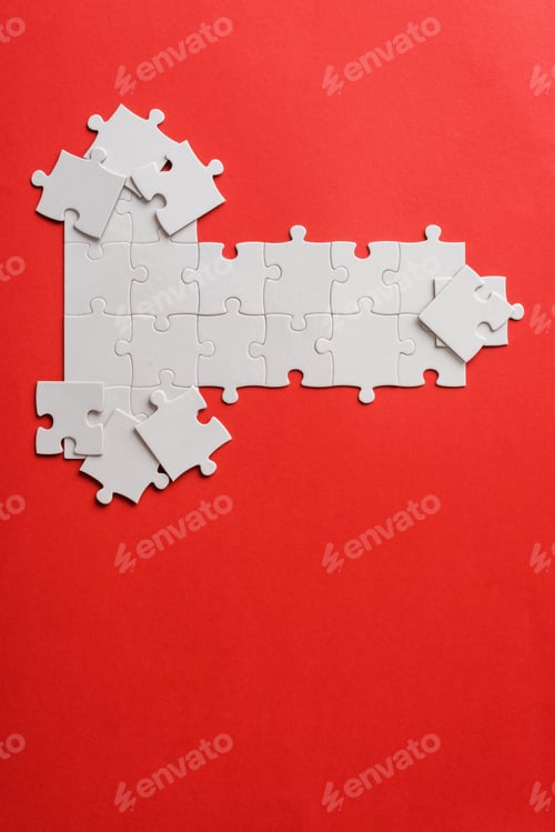 Preview: top view of white connected puzzle pieces near shapes on red