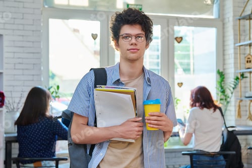 Preview: Male student with takeaway coffee in college coffee shop