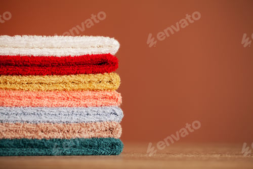 Preview: Stack of fresh towels on table in bathroom