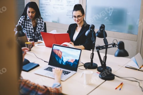 Preview: Group of colleagues working together in workspace