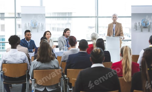 Preview: Female speaker speaking in business seminar in modern office building