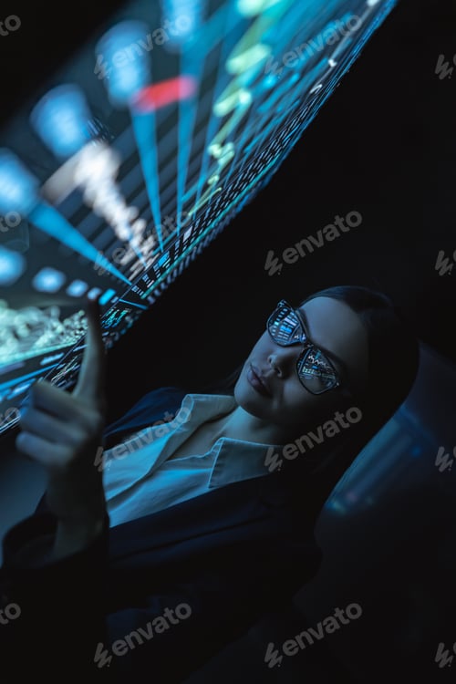 Preview: The business lady works with sensor monitor in the dark office.