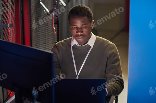 Preview: Focused Technician Working in Data Center Monitoring Servers