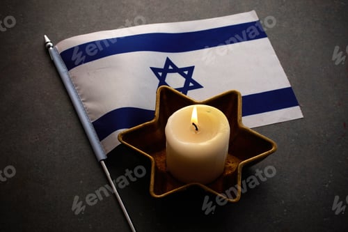 Preview: Burning candles and flag of Israel on dark background. Holocaust remembrance day