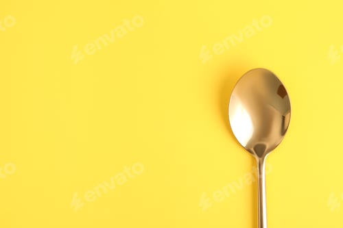 Preview: Clean tea spoon and space for text on color background, top view