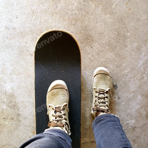 Preview: low section of person standing on skateboard