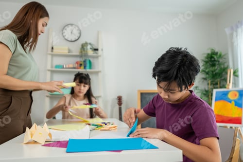 Preview: Asian teacher educating students in an art class at elementary school.