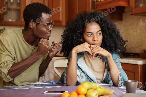 Preview: Black full of anger husband clenching fists mad at his indifferent wife, desiring for explanations,