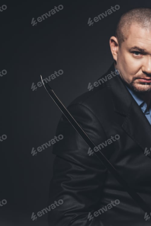 Preview: close-up shot of modern samurai with katana sword on black