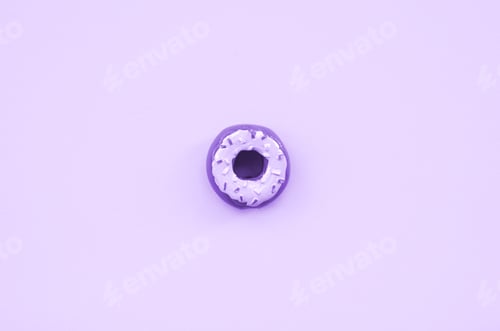 Preview: Single small plastic donut lies on a pastel colorful background. Flat l
