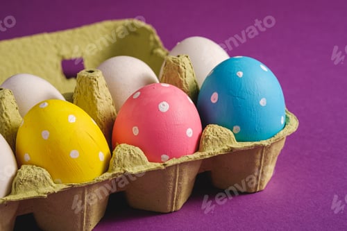 Preview: Colorful Easter Eggs in a Carton on Purple