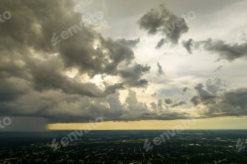 Preview: Dark stormy clouds forming on gloomy sky during heavy rainfall season over suburban town area