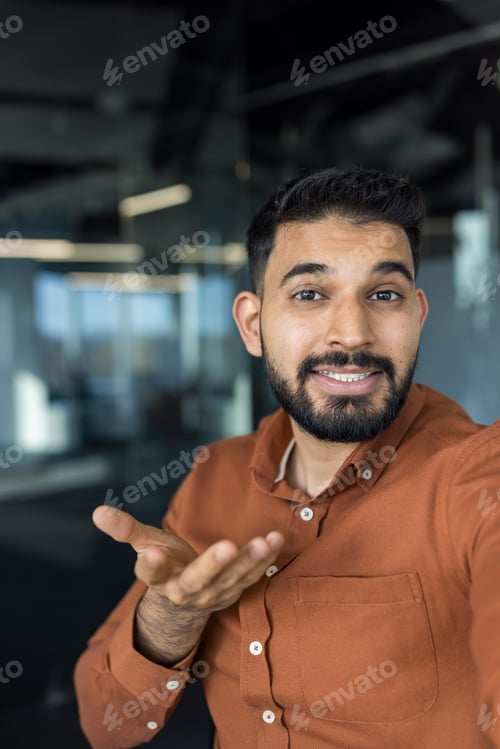 Preview: Young bearded man gesturing while having a video call