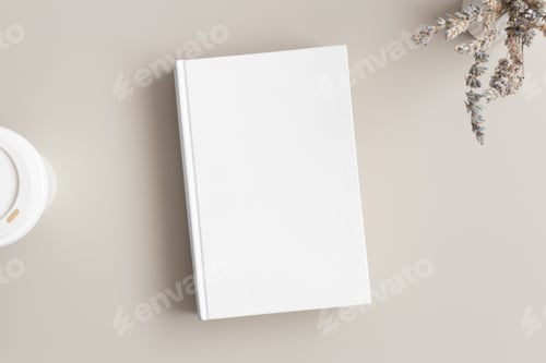 Preview: White book mockup with a lavender and a coffee paper cup on a beige table.