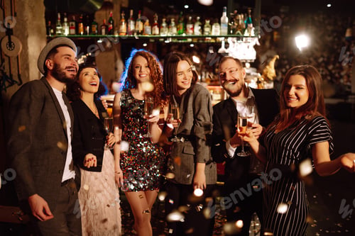 Preview: Happy friends throwing confetti, jumping while enjoying party. Confetti is fun. Party, celebration.