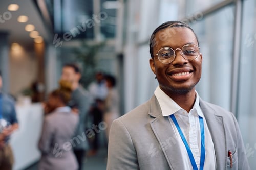 Preview: Portrait of happy black businessman looking at camera.