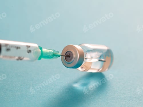 Preview: Vaccine vial dose and syringe against pale blue background