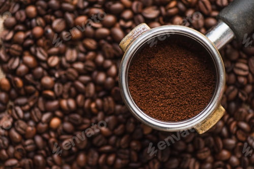 Preview: top view of ground coffee in portafilter on coffee beans background