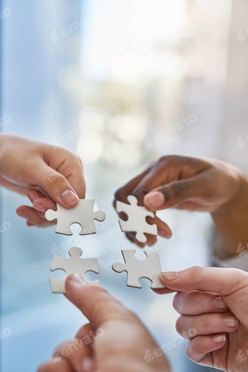 Preview: Joining together as a team. Shot of hands putting puzzle pieces together.