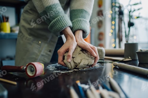 Preview: Ceramist kneading clay in pottery workshop