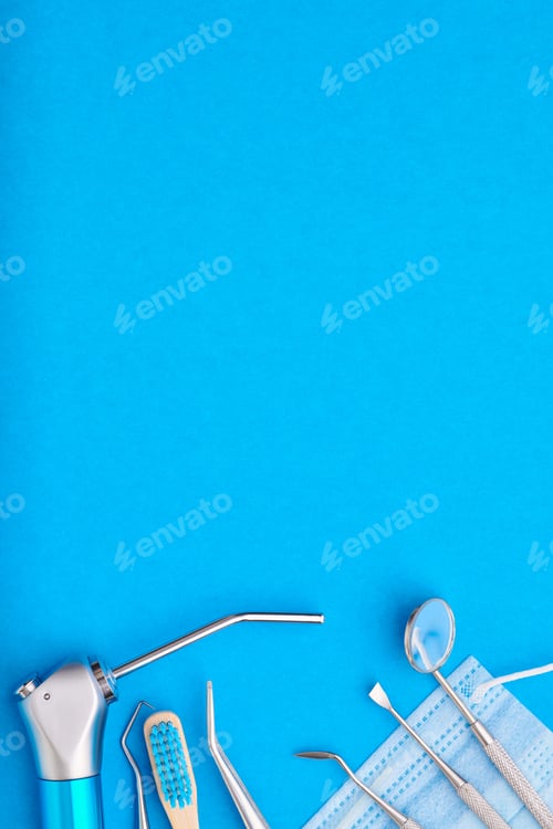Preview: Dentist tools over blue background top view