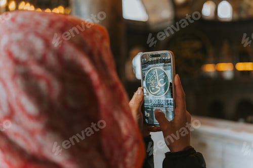 Preview: Tourist taking photo of arabic calligraphy inside hagia sophia mosque