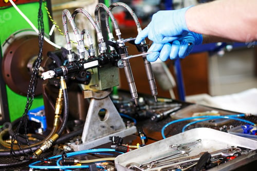 Preview: Professional mechanic testing diesel injector in his workshop.