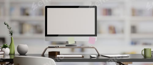 Preview: Office desk with pc computer on table over blurred bookshelf background.