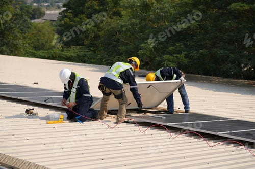 Preview: Engineer installing solar cell panels on roof.