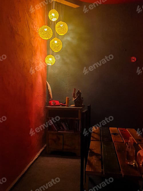 Preview: Small poorly lit cafe room with retro interior design