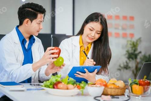 Preview: Two nutritionists,female and male, work in a hospital, analyzing vegetable and fruit salads