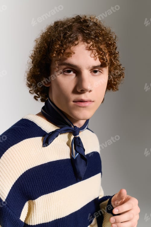 Preview: Stylish teenager showcases unique fashion sense in a creative studio setting