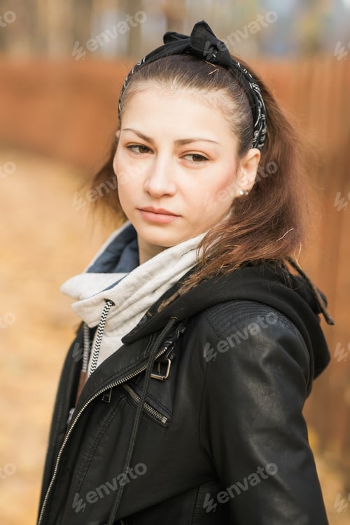 Preview: Outdoor atmospheric lifestyle portrait of young beautiful young woman. Warm autumn fall season
