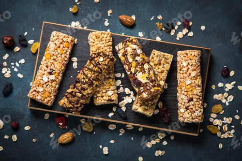 Preview: Granola bar with nuts, fruit and berries on black.