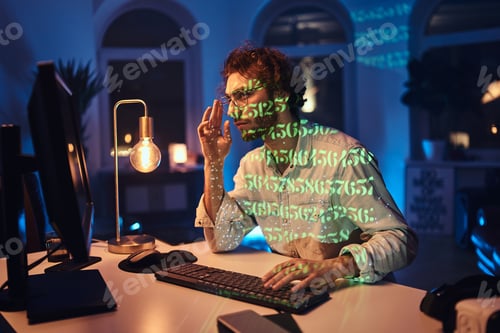 Preview: Professional programmer doing his job on computer in dark office