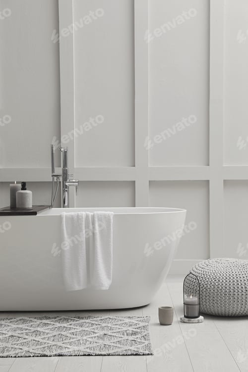 Preview: Modern ceramic bathtub near white wall indoors
