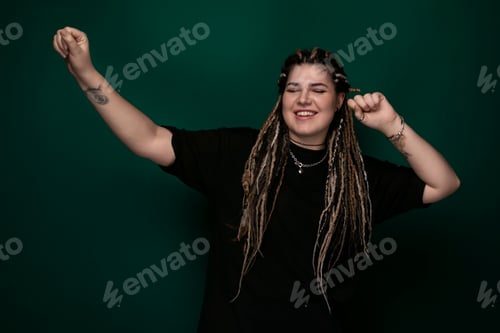 Preview: Woman With Dreadlocks in Front of Green Background