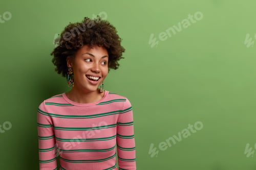 Preview: Smiling Woman in Striped Shirt Looking Away