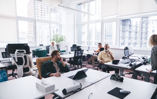 Preview: Group of diverse colleagues working in modern workplace