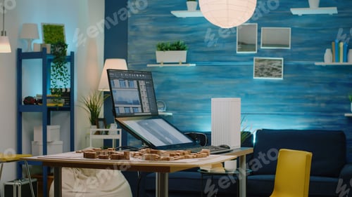 Preview: Man architect using touch screen monitor with building model